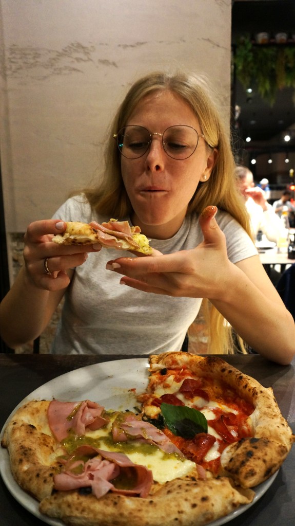 Emily eats pizza at Diego Vitagliano Pizzeria in Naples, Italy, a pizzeria that tied for #4 in the world according to a 2025 ranking. 